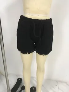 Women's black high-waist denim shorts with fringe hem and drawstring waist