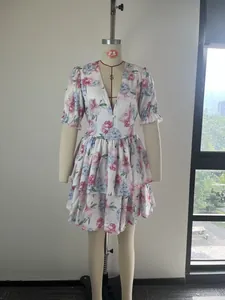 Elegant V-neck floral print dress with puff sleeves and ruffled hem displayed on a mannequin