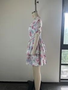Side view of an elegant V-neck puff sleeve tiered floral print dress on a mannequin.