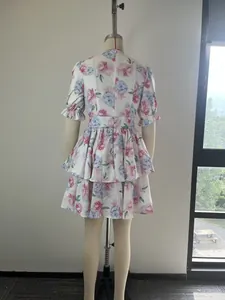 Rear view of an elegant floral print puff sleeve tiered ruffle mini dress on mannequin