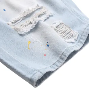 Men's light blue ripped denim shorts with colorful paint splatter design