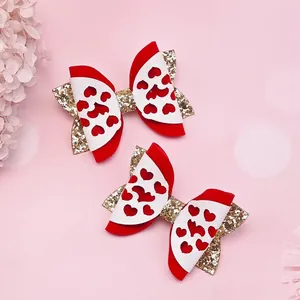 Detailansicht handgefertigter Valentinstag-Haarspangen mit roten Schleifen und Herzen.