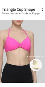 Detail view of a pink halter sports bra featuring tear-drop shaped padding inserts.