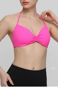 Detailed view of pink halter sports bra featuring soft velvet wrapping fabric.