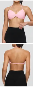 Front and back view of a pink halter sports bra with thin straps and quick-dry fabric.