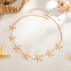Exquisite detail of gold starfish body chain with pearl accents on a beach-themed background