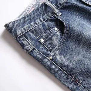Close-up of distressed blue denim shorts showing pocket detail and washed texture