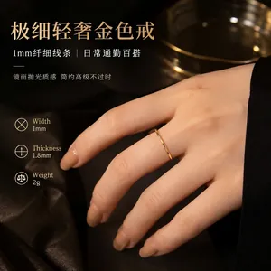 Detailopname van een minimalistische 1 mm dunne gouden roestvrijstalen ring aan vinger