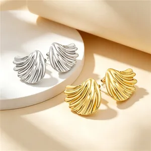 Detailed view of pleated lotus leaf titanium steel earrings in gold and silver finishes