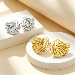 Detailed view of brushed 18K gold and silver lotus leaf titanium steel stud earrings