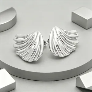 High-detail view showing the pleated texture of silver leaf-shaped titanium earrings