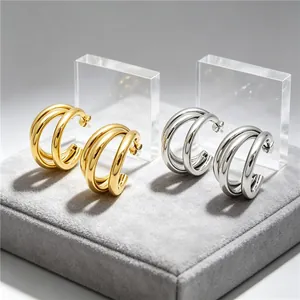 Elegant minimalist stainless steel triple-hoop C-shaped earrings in gold and silver finishes.