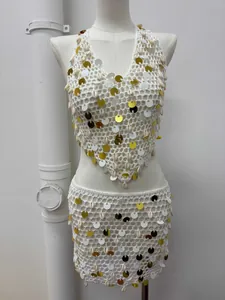 Detailed crochet texture with golden sequins and seashells on white two-piece set