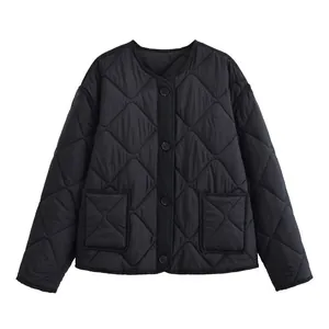 Detailed view of a black quilted jacket featuring a round neck and button closure.