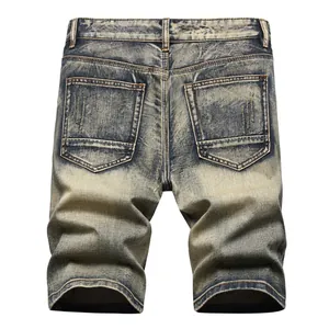 Vintage distressed men's denim shorts with a washed finish and a slim fit design.
