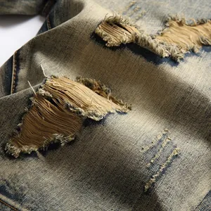 Close-up view of high street ripped distressed denim shorts with a unique vintage wash effect