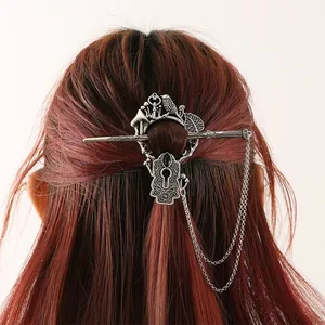 Vintage silver alloy hair slide with mushroom bird and keyhole charms on hair