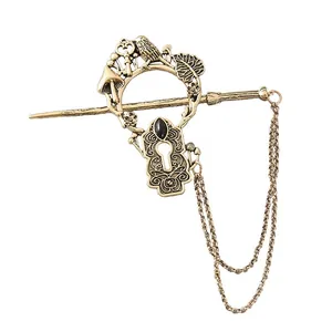 Detailed view of antique gold alloy hairpin with bird and mushroom motifs