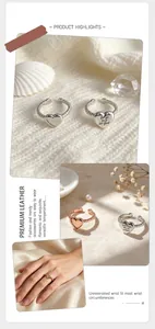 Close-up of elegant stainless steel heart-shaped rings with engraved inspirational quotes