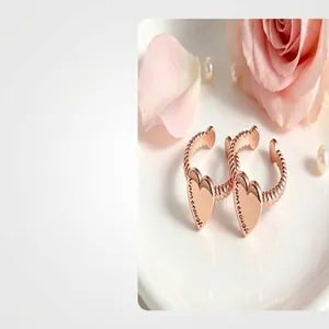 Detailed view of rose gold heart ring with "I am enough" engraving on band.