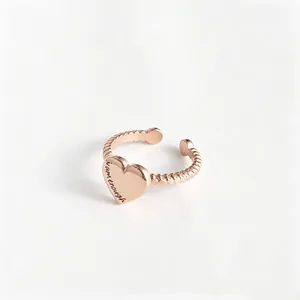 Rose gold heart-shaped ring with iamenough engraving on twisted stainless steel band