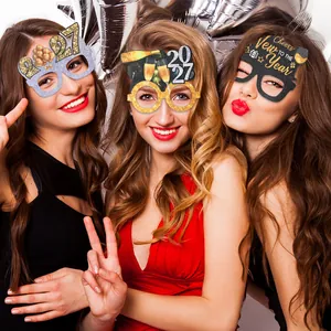 Three women wearing festive 2027 New Year party paper glasses photo props