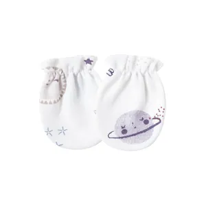 Close-up detail of soft white cotton baby anti-scratch mittens with celestial prints