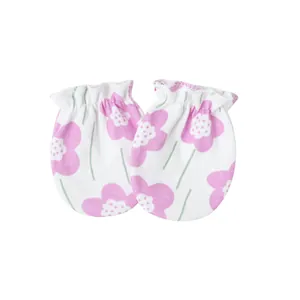 Detail view of newborn anti-scratch mittens with pink floral print and elastic bands