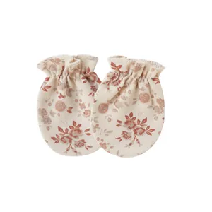 Detailed macro view of soft cotton baby mittens with vintage floral print for newborns.