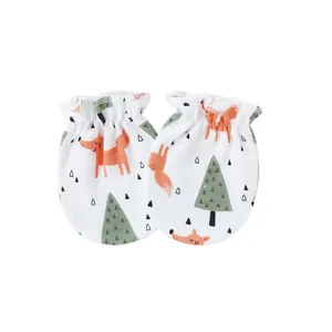 Detail of newborn baby anti-scratch mittens featuring cute fox and pine tree print