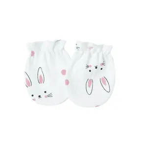 Detail view of white newborn anti-scratch mittens with a cute pink bunny pattern