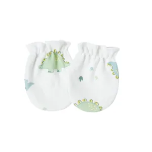 Close-up view of soft newborn baby mittens with a cute green dinosaur print pattern