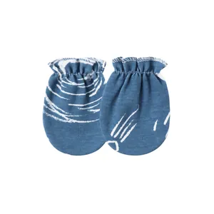 Macro detail of soft baby anti-scratch mittens featuring a blue and white print.