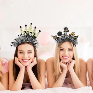 Black and gold New Year party tinsel headbands with crown and cheers decor motifs