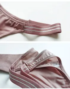 Detailed macro view of mauve ice silk thong featuring striped elastic waistband stitching
