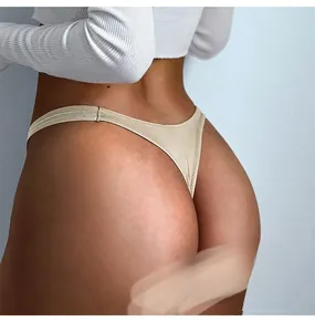 Close-up detail of sexy champagne ice silk thong with low waist high cut design