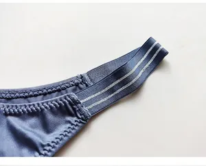 Detailed macro view of blue ice silk thong featuring silver striped elastic waistband