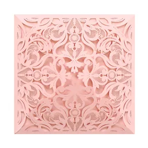 Detailed view of elegant pink laser-cut lace invitation card cover for wedding parties