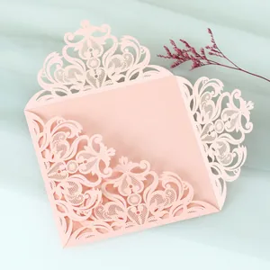 Detail of pink laser-cut lace wedding invitation card shell with floral patterns