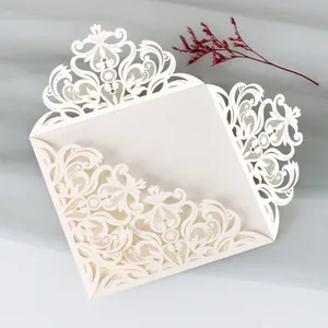 Macro view of elegant laser-cut ivory lace patterns for wedding invitation covers