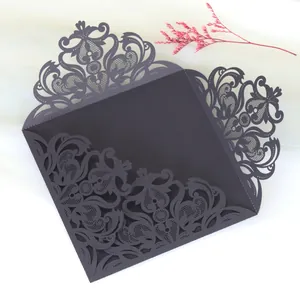 Intricate laser-cut lace floral pattern on elegant dark wedding invitation sleeve