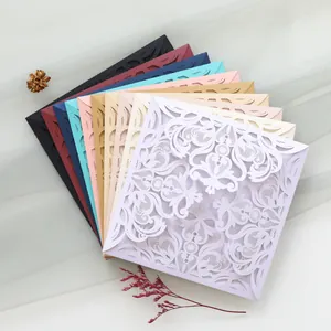 Detailed view of laser cut lace wedding invitation covers in various elegant colors.