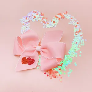 Detail showing a pink handmade heart bow hair clip for girls, perfect festive gift.