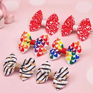Detail of handmade heart-patterned bow hair clips in various vibrant designs for kids.
