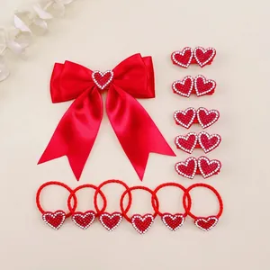 Detailed view of red heart bow hair clip and elastic tie set for kids