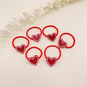 Set of six red elastic hair ties featuring sparkly rhinestone heart decorations