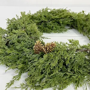 Close-up of artificial cypress garland with glittered pinecones for Christmas decoration.