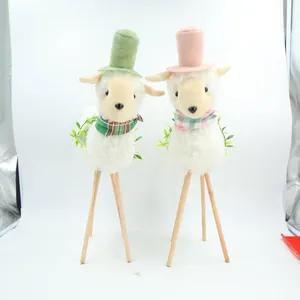 Detail showing two pastoral sheep figurines with top hats and wooden tripod legs
