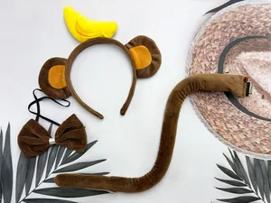 Detail view of brown plush monkey ears headband with banana, tail, and bow tie set
