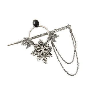 Macro view of a vintage silver punk style hair pin with maple leaf and snowflake charms